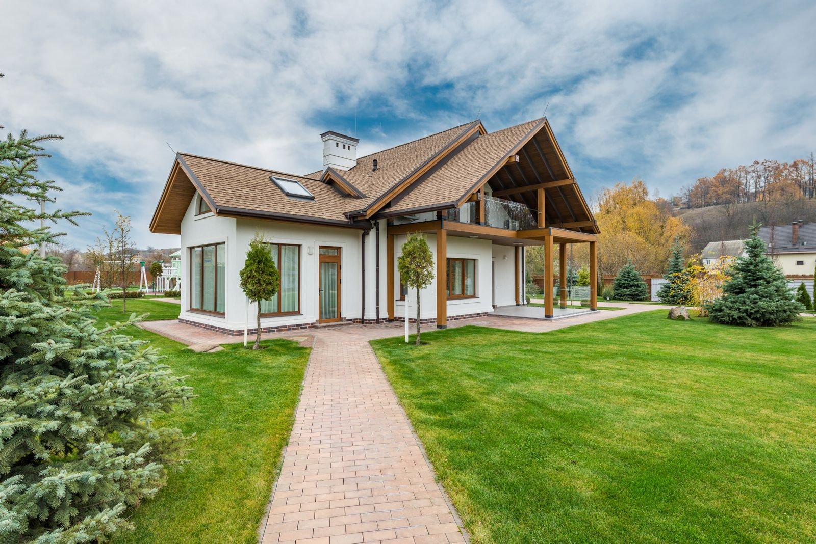 Small detached backyard cottage surrounded by lawn and trees