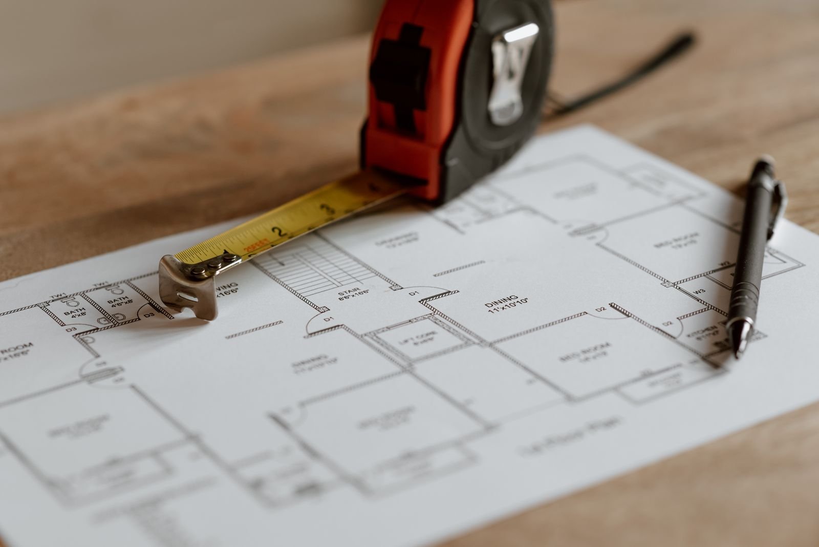 Ruler and pencil resting on a set of building plans